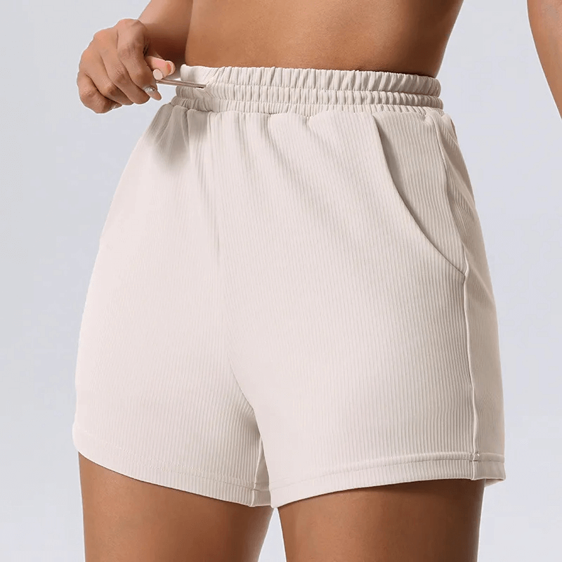 Stylish elegant women's ribbed yoga shorts with pockets, perfect for yoga, running, and fitness. Versatile activewear for all seasons.